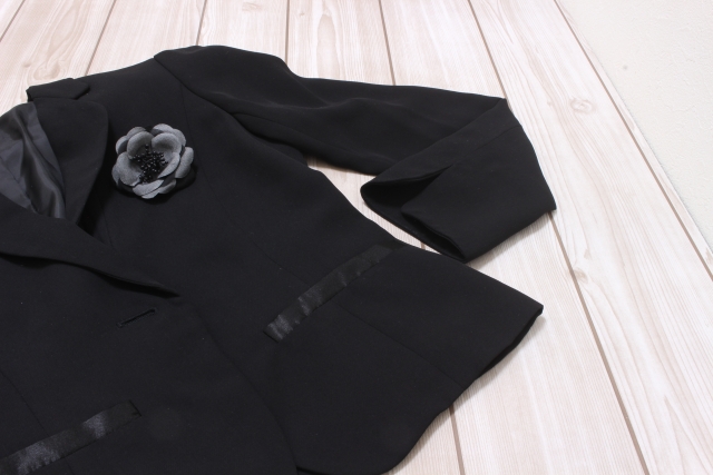 黒いジャケットとコサージュの写真